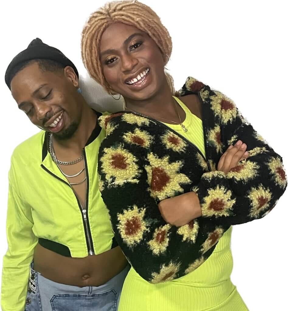 Left to right
White background
Black queer person eyes closed with a black hat. Silver chains around neck with a lime green crop top jacket. Smiling and looking down.
Black Trans woman with blonde locs smiling looking into the camera. Wearing a lime green dress and a cropped black and yellow sunflower jacket. Arms folded.