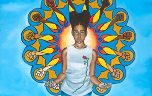 Painting of a Black girl floating in a bright blue sky with bare feet, jeans, and a white tank top decorated with a rose on the heart side of her body. She floats with her legs together and her arms bent at the elbow and her palms facing up so she appears to be offering us something or meditating. Her double-bunned hair is surrounded by a halo of fists of varying skin tones. This halo is elaborate like a mandala and includes a lot of abstract swirls and bright warm colors like yellow and orange.